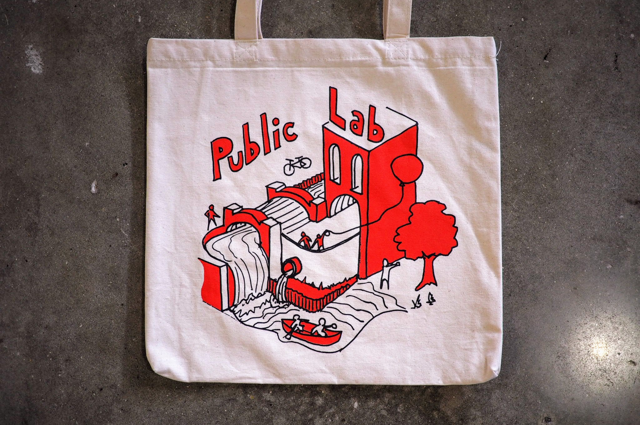 a tote bag bearing the same drawing as the sticker above but in red