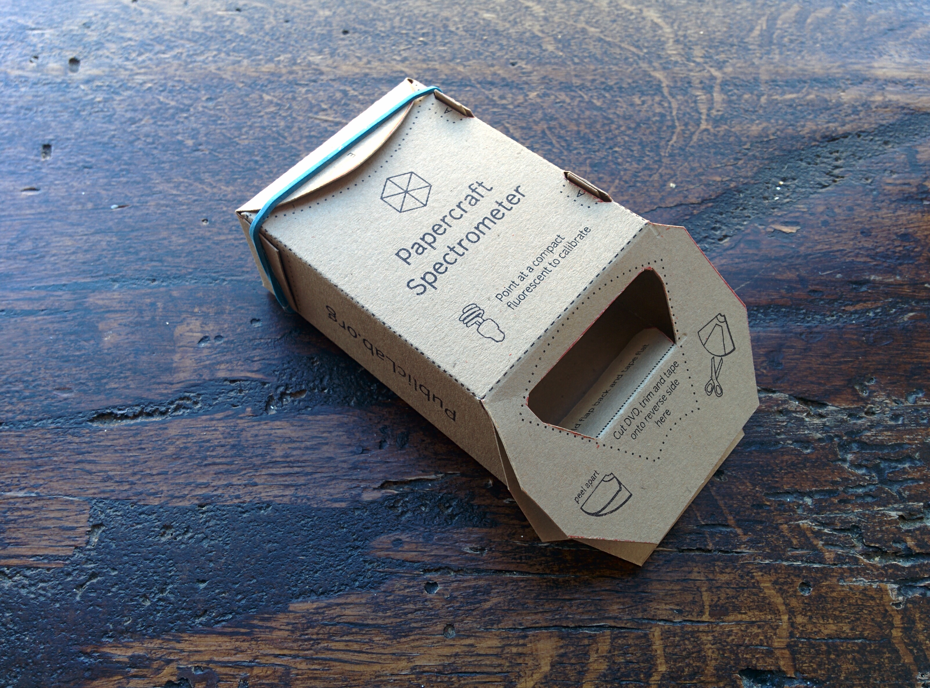 the papercraft spectrometer assembled, on a wooden table
